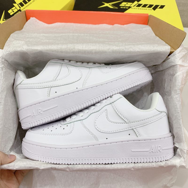 a pair of white sneakers in a boxgiay